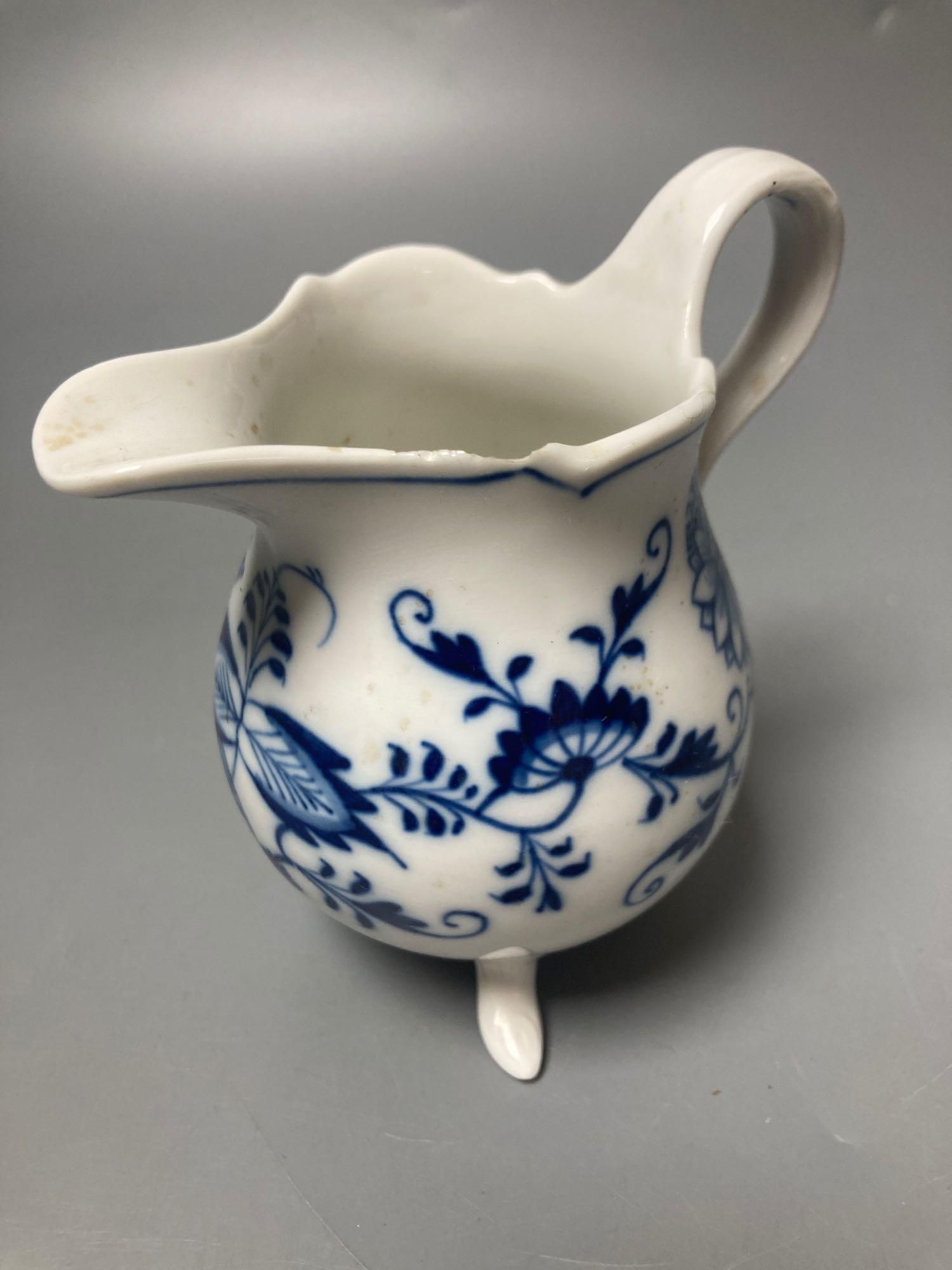 A Meissen blue and white onion pattern jug and a similar leaf shaped pickle dish (2)
